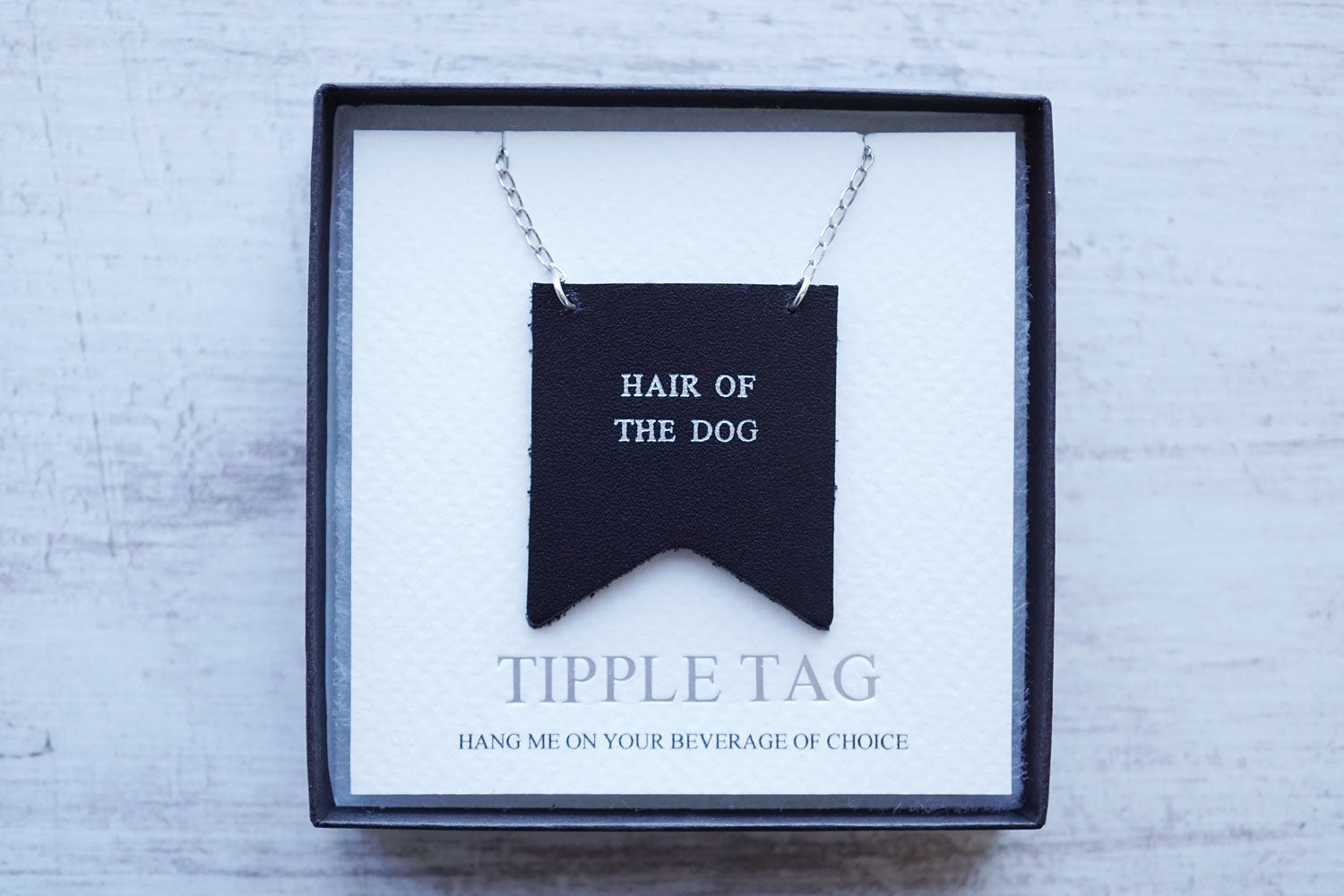 Custom decanter tags with the phrase Hair of the dog