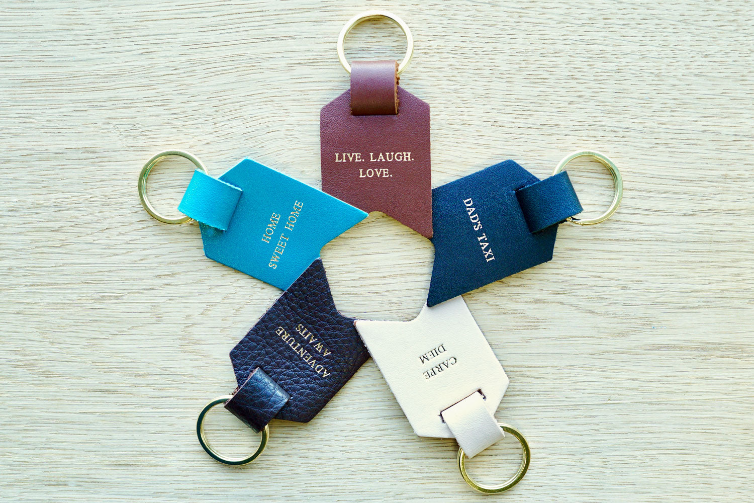 Personalised Keyrings for Dad from Bookshell Bindery, available in Black, Dark Brown, Light Brown, Turquoise blue and Cream