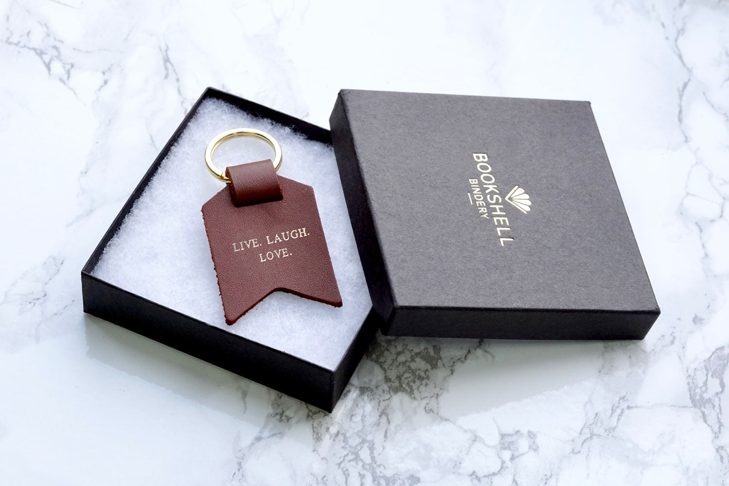 Personalised Keyrings for Dad from Bookshell Bindery, this one is light brown leather embossed with the phrase Live, Laugh, Love