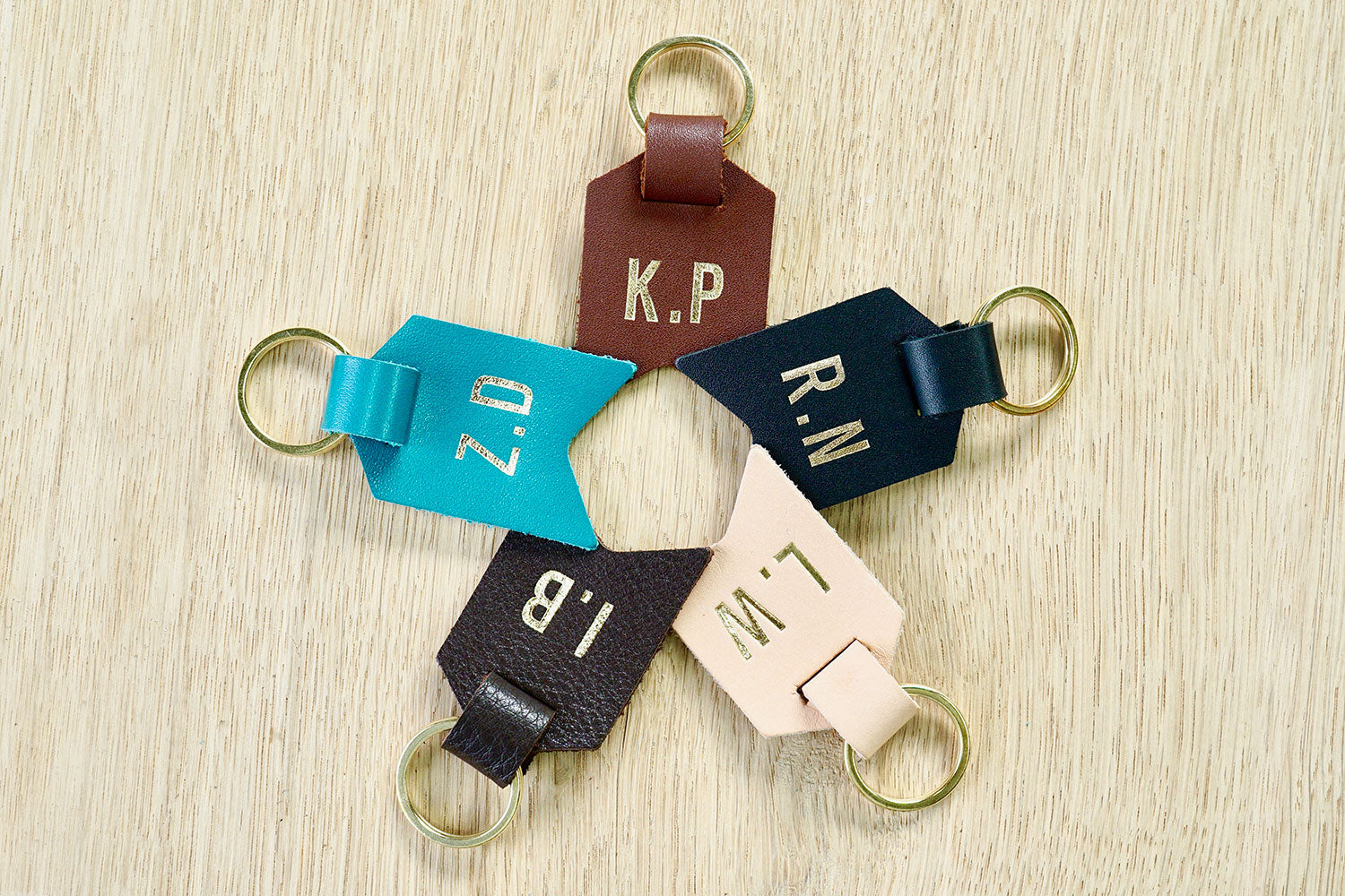 Personalised Daddy keyring from Bookshell bindery available in black leather, turquoise blue leather, dark brown leather, light brown leather, Natural (pale pink)