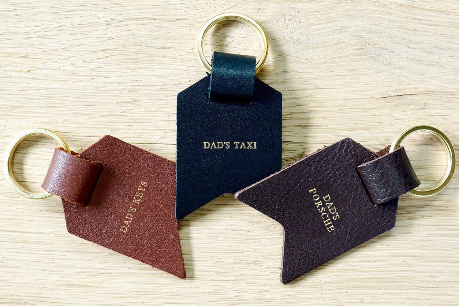 Personalised Daddy keyring from Bookshell Bindery with Dad's keys, Dad's taxi and Dad's Porsche embossed with gold foil