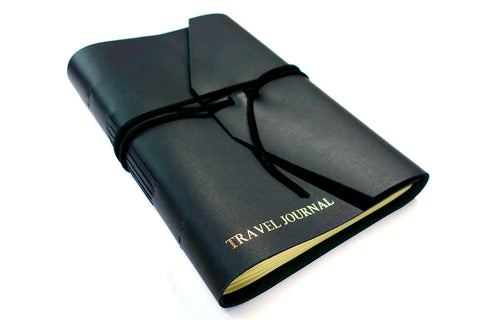 Personalized leather journal in black leather from Bookshell bindery with Travel Journal embossed in gold on the cover